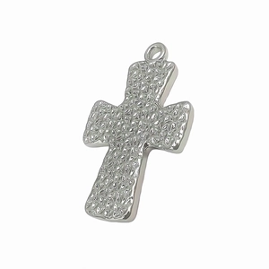 Detailed view of silver cross pendant featuring a unique hammered rock texture surface