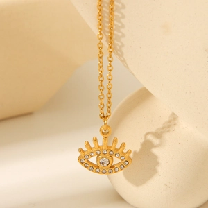Macro detail of 18K gold plated evil eye pendant necklace with pavé zircon stones