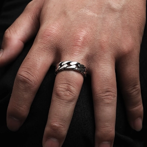 Detail view of a men's industrial Cuban chain ring in antique silver stainless steel