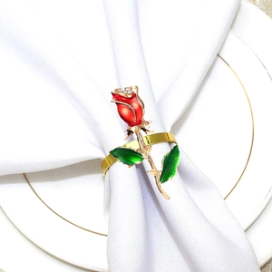 Detail of red rose napkin ring with sparkling rhinestones on elegant hotel table