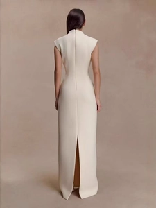 Rear view of white sleeveless maxi dress featuring a high back slit and slim-fit silhouette