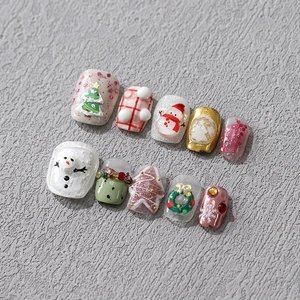 3D embossed Christmas nail stickers featuring snowman and tree designs in festive colors