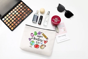 Flat lay of Happy Teachers' Day makeup bag with festive icons and cosmetic props