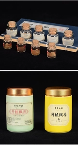 Detailed view of traditional handmade incense pearls in labeled glass and ceramic jars