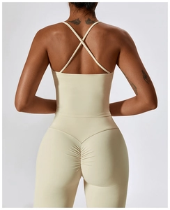 Detail of cross-back yoga bra and ruched leggings in cream for fitness and workout