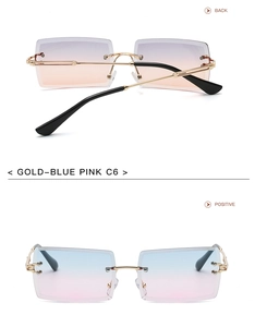 Close-up of frameless square sunglasses with gold arms and blue-pink gradient lenses