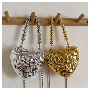 Metallic heart-shaped acrylic dinner bag with hammered texture and beaded top handle