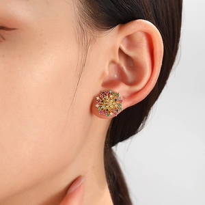Elegant gold flower earrings with colorful zircons and pearls worn by a model