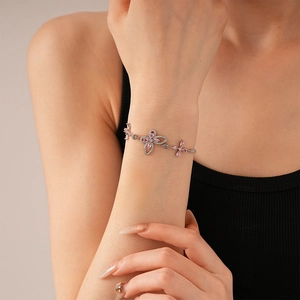 Macro detail of silver S925 bracelet with pink butterfly and flower zircon stones
