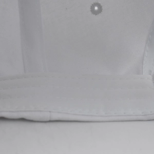 Macro detail of high-quality stitching and breathable eyelet on the white captain hat