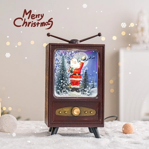 Retro TV snow globe decoration with Santa Claus and cedar inside warm festive setting
