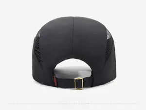 Detail of breathable mesh panels and adjustable metal buckle on the black quick-dry cap