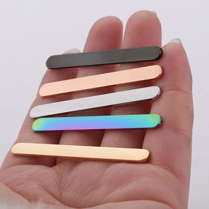 Detailed view of five multi-colored 5mm polished stainless steel blank strips for rings