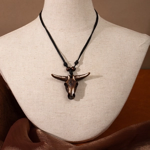 Detail of Maori fish hook resin pendant necklace on mannequin with woven black rope