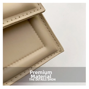 Macro shot of elegant beige quilted leather handbag showing fine stitching and texture
