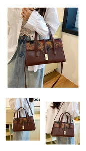 Detail of dark brown leather handbag with vintage oil painting print and gold metal buckle