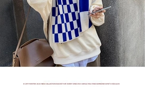 Detailed knit texture of a classic blue and white checkerboard scarf styled for winter