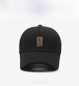 Detailed view of the black textured baseball cap featuring a leather logo patch
