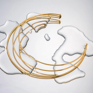 Macro detail of multi-layered 14K gold plated stainless steel choker with water droplets