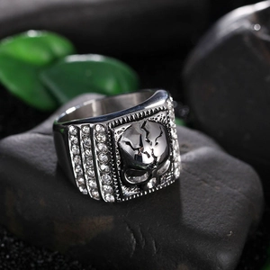 Detail of silver skull ring for men with polished steel finish and white zircon stones