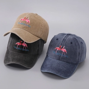 Three washed cotton baseball caps in khaki, black, and navy with flamingo embroidery