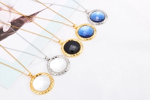 Detailed shot of multi-color crystal pendants with gold and silver plated gear edges