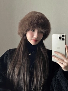 Close-up of fluffy dark brown faux fur bucket hat showing plush texture and warmth