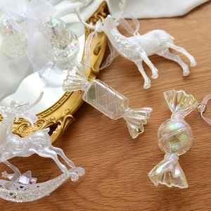 Iridescent Christmas tree ornaments featuring colorful glitter deer and candy shapes