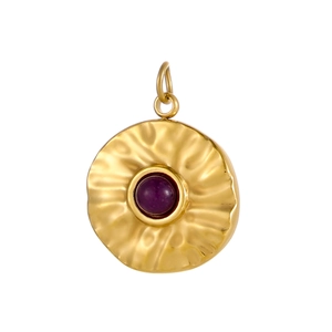 Macro detail of gold-plated pendant featuring a hammer-textured finish and purple gemstone