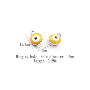 Macro detail of silver-rimmed yellow evil eye alloy charm with double loops for DIY jewelry