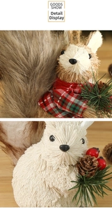 Detail of woven straw squirrel decorations with pine cones and festive red berries