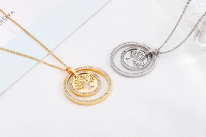 Detailed view of gold and silver hollow life tree pendants with cubic zirconia