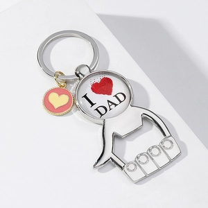 Detail of silver Father's Day bottle opener keychain with I Love Dad design and heart charm