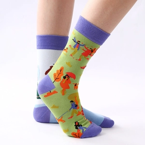 Women's green crew socks with colorful autumn illustrations and purple contrast toe