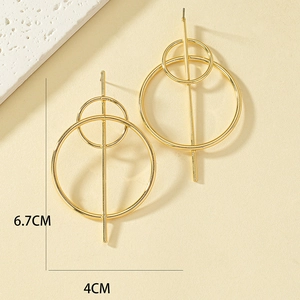 Detail view of gold geometric hoop earrings with 6.7cm length and 4cm width dimensions