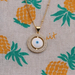 Collier œil protecteur doré avec pendentif rotatif en émail bleu et cristaux brillants