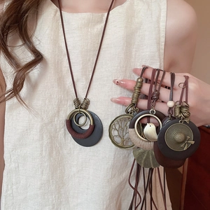 Close-up of Bohemian wood and bronze alloy pendant necklace with a Tree of Life design