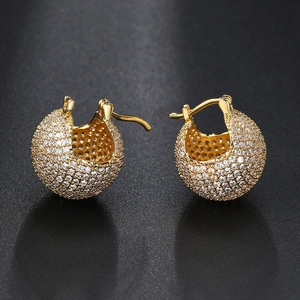 Macro shot of gold-plated pave set zircon ball earrings with micro-inlaid rhinestones