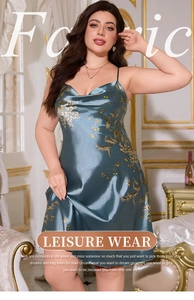 Detail of teal satin slip dress showing silky texture and intricate gold floral print