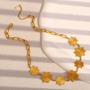 Detail of gold 18K plated stainless steel necklace with spiral textured disc pendants