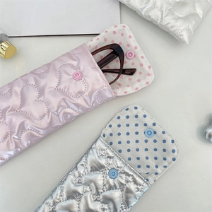 Detail of heart-quilted PU leather sunglass cases with soft dotted lining and snap closure