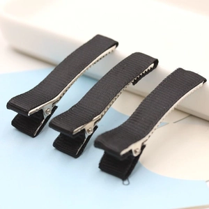 Detailed view of black fabric wrapped metal alligator hair clips with inner teeth design