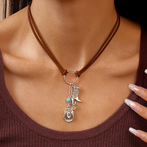 Detail of Western double-layer necklace with cowboy boot, hat, and cactus pendants