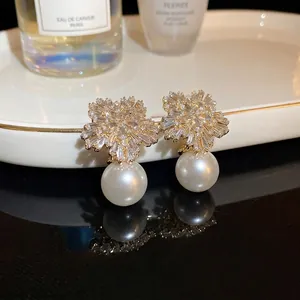 Elegant snowflake pearl earrings with sparkling crystals and gold plating for women