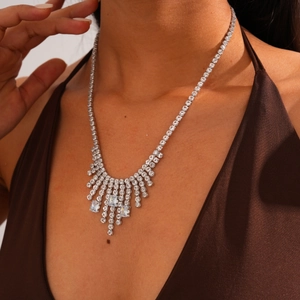 Close-up of elegant silver tassel sweater necklace with geometric zircon fringe details
