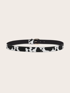 Detail of faux calf hair belt with cow print texture and golden metal pin buckle