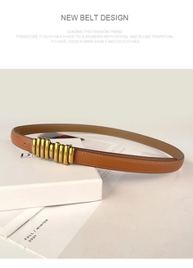 Detail of genuine leather belt with unique gold spiral buckle on elegant display