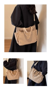Detail of beige corduroy tote bag showing ribbed texture and side pockets