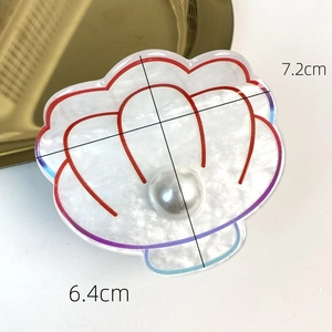 Detailed view of pearl shell hair claw with red texture and size marking of 7.2cm x 6.4cm