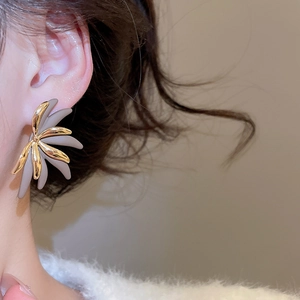 Close-up of 18k gold plated flower stud earrings with grey petals on model